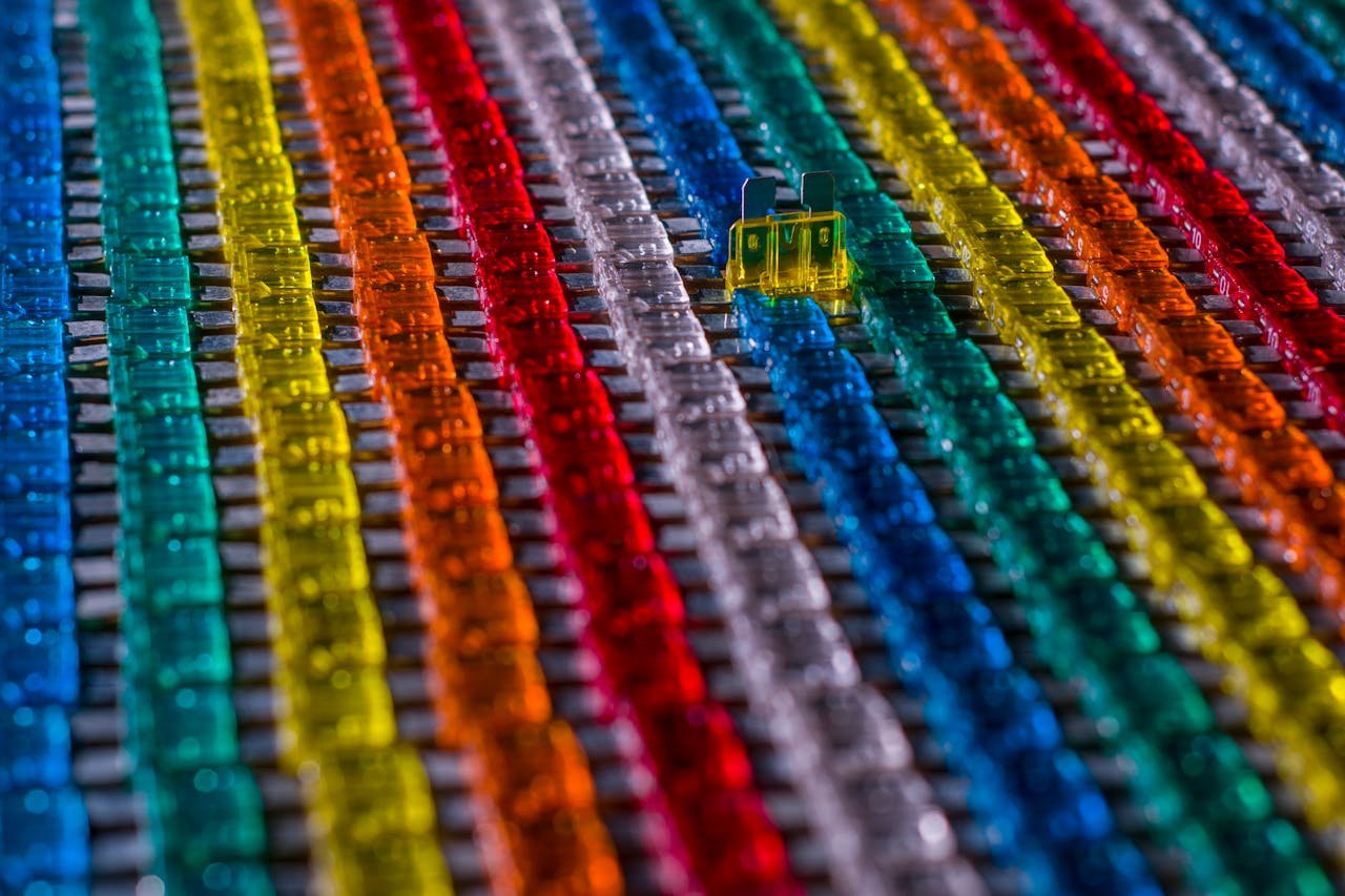 Rows of multicolored car electrical fuses